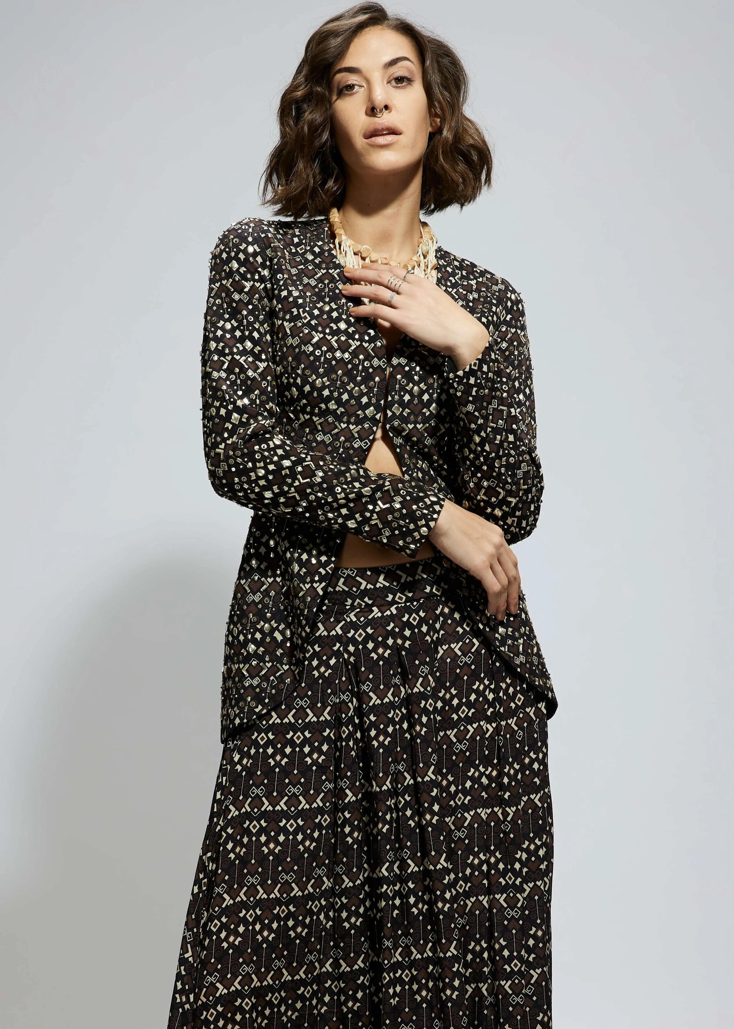 Black embellished jacket and printed flared pants