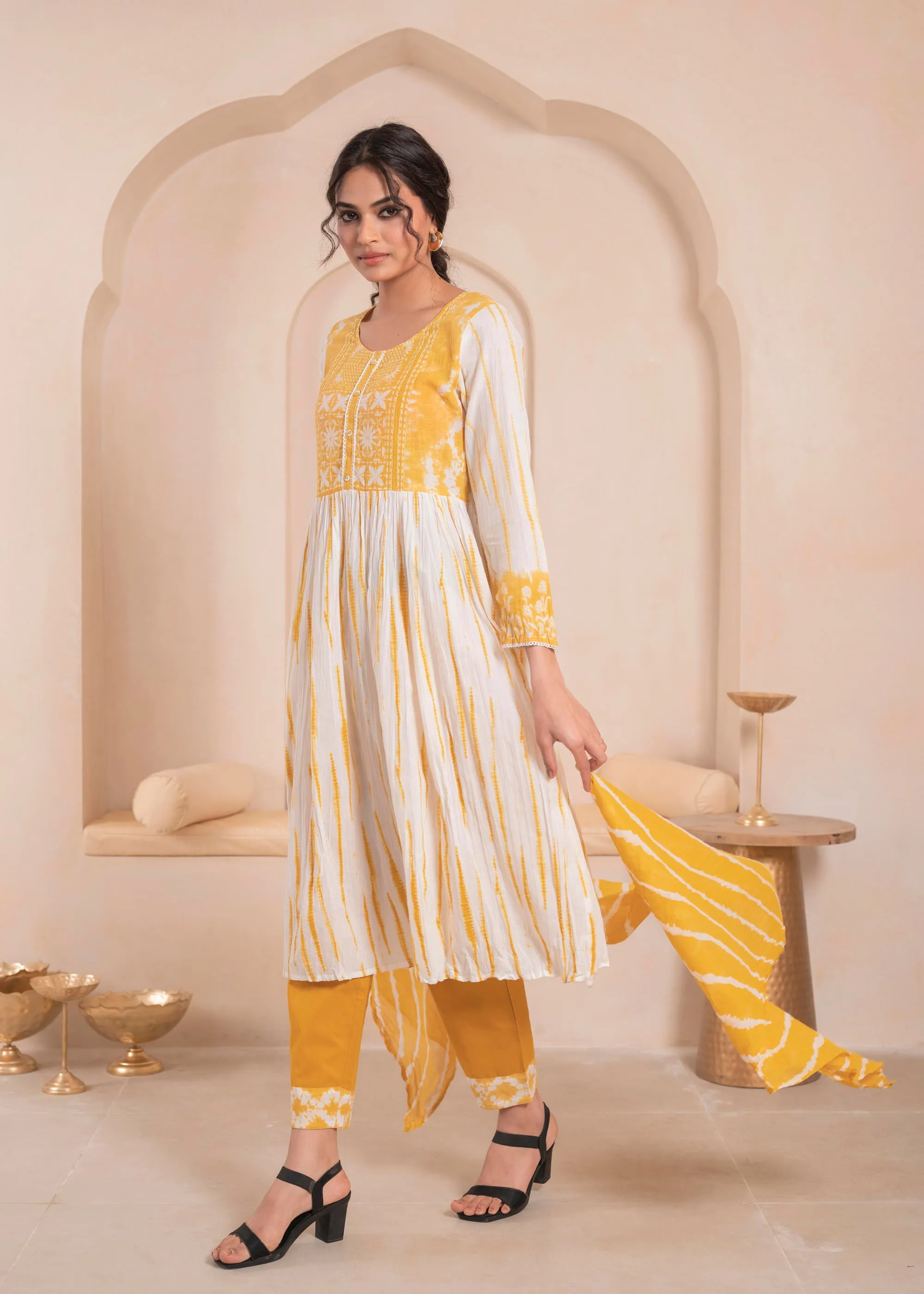Mustarad and white kurta , solid bottom and tie - dye dupatta with cotton lace , buttons , sequince