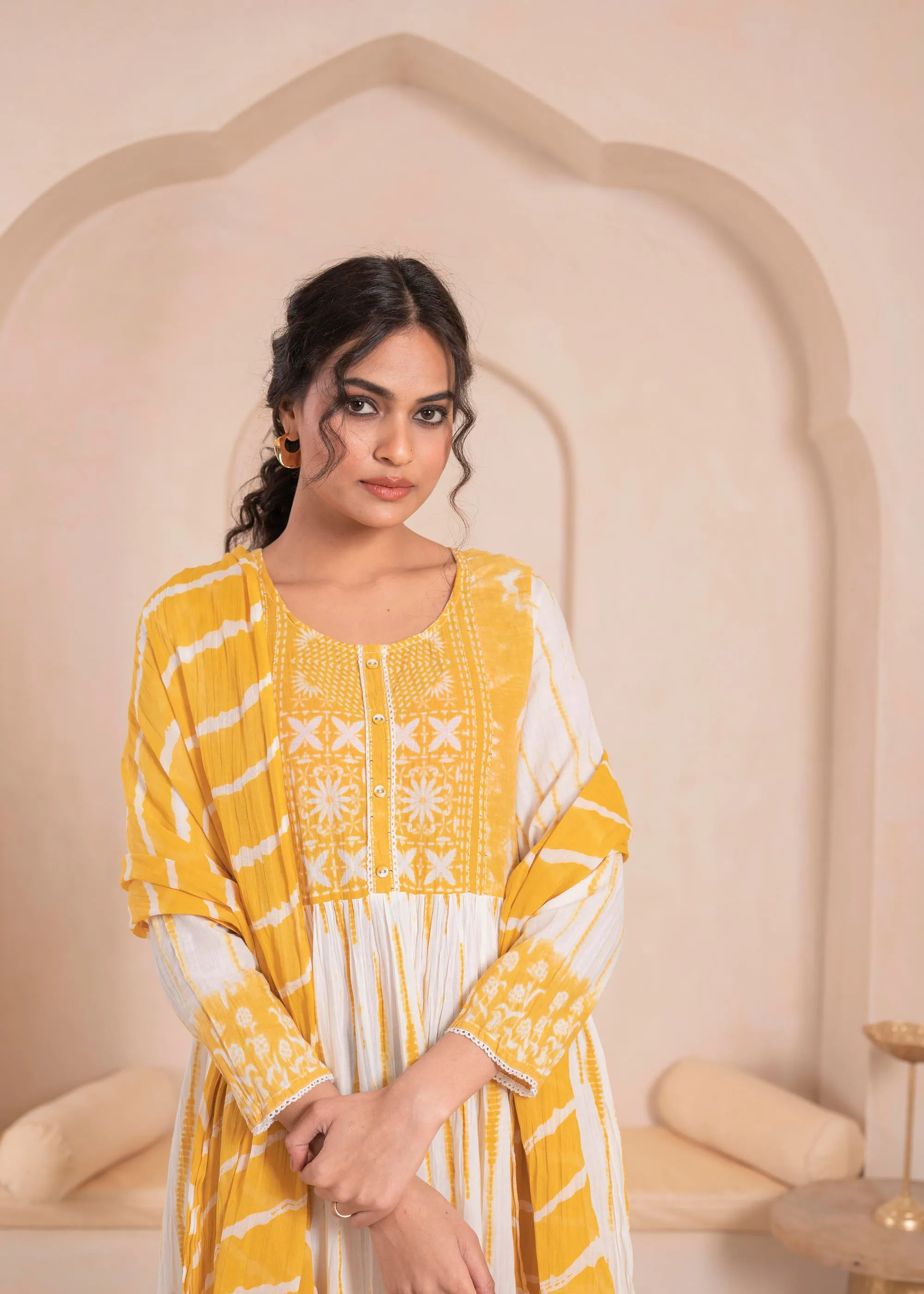 Mustarad and white kurta , solid bottom and tie - dye dupatta with cotton lace , buttons , sequince