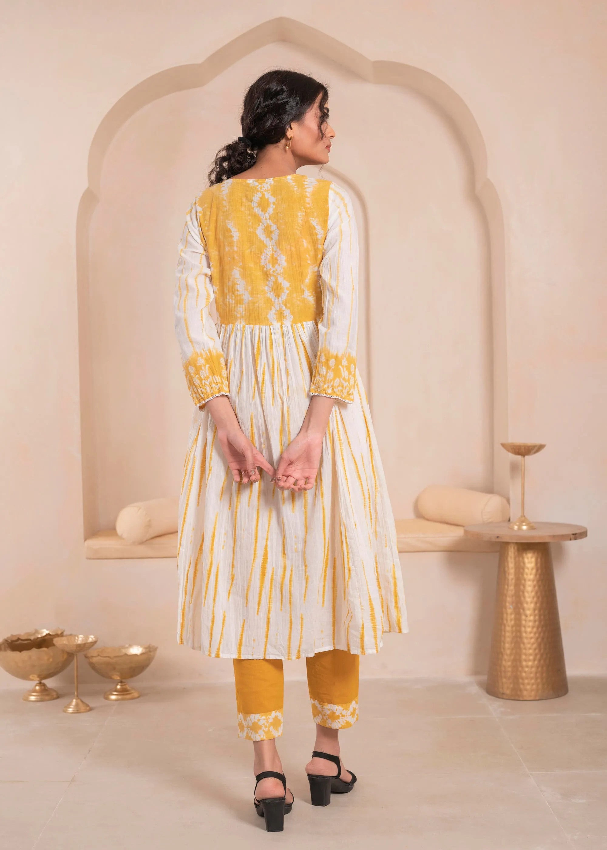 Mustarad and white kurta , solid bottom and tie - dye dupatta with cotton lace , buttons , sequince